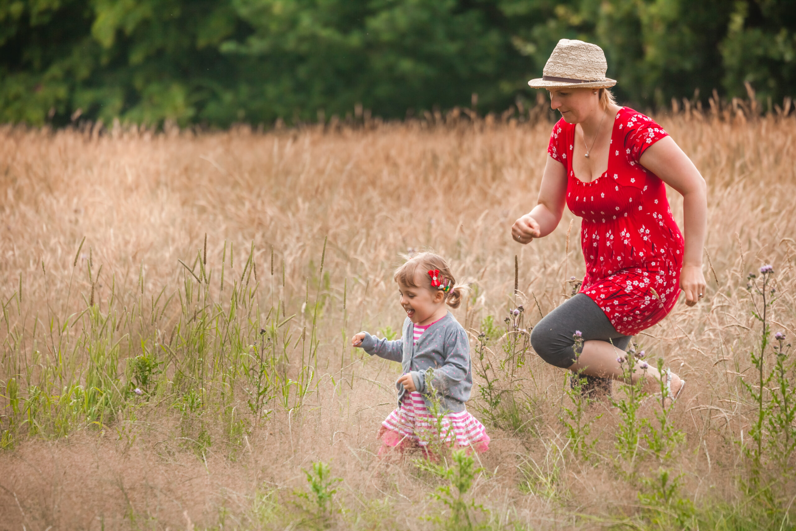 Mother and daughter playing together on a meadow